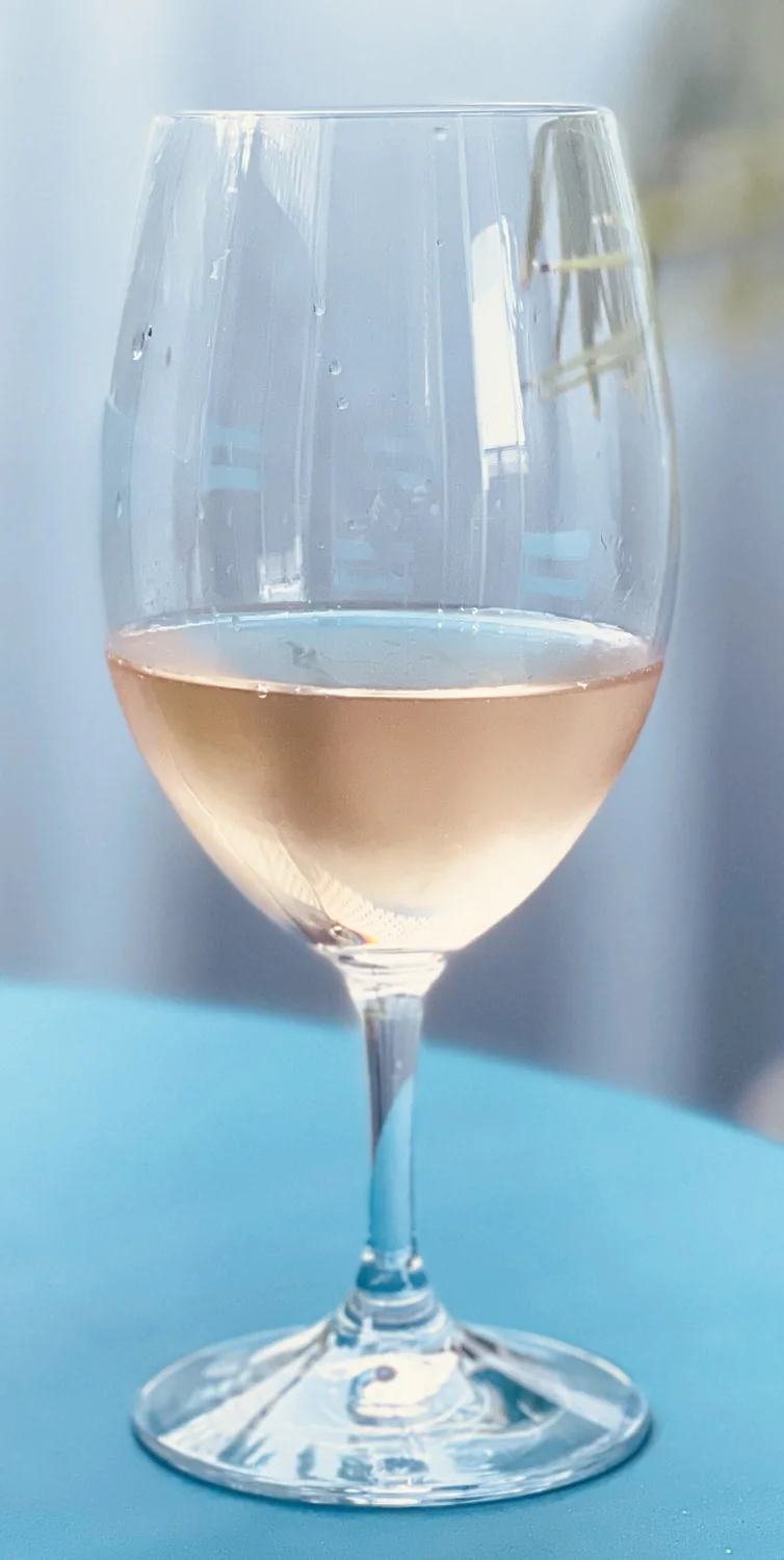 A glass of pale rosé wine